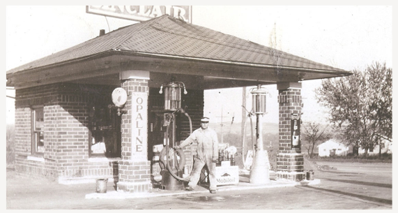 Leonard Holt, the great grandfather of the current owners standing next to the gas pumps as it was in 1927